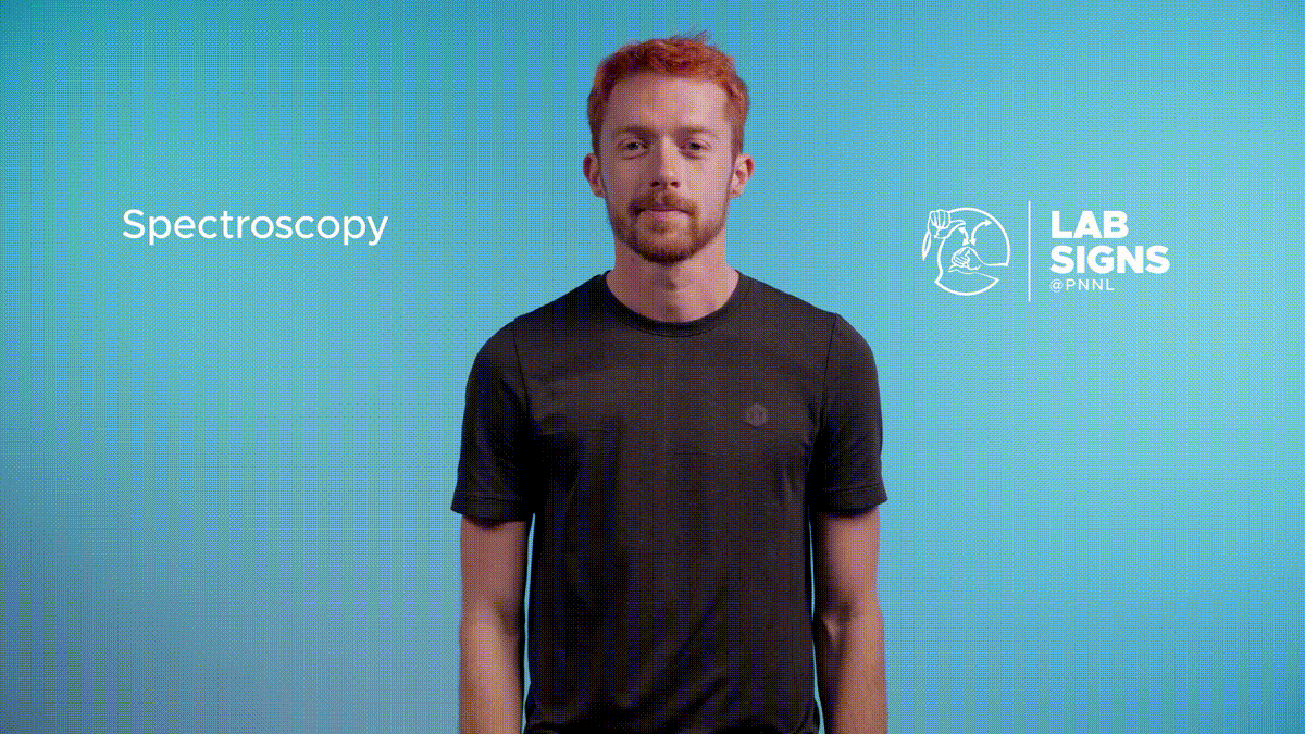 A newly designed ASL sign for spectroscopy, signed here by Cooper Norris, invokes a mostly-flat baseline spectrum with several sharp emission lines.