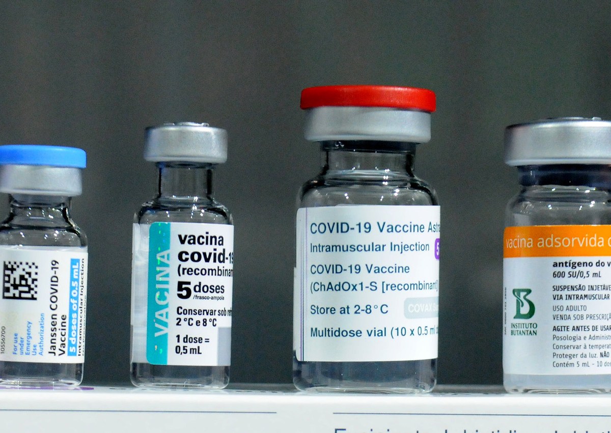Four bottles of the COVID-19 vaccine sit in a row.