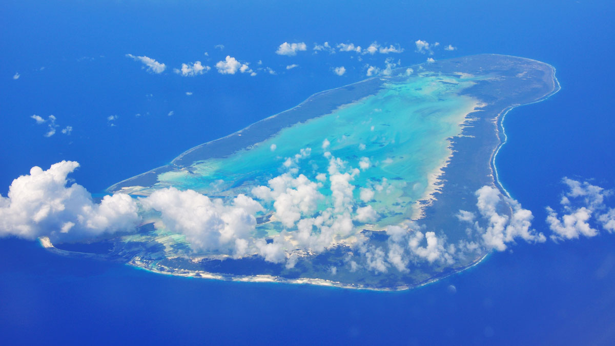 An atoll (a ring-shaped island) is seen from above.