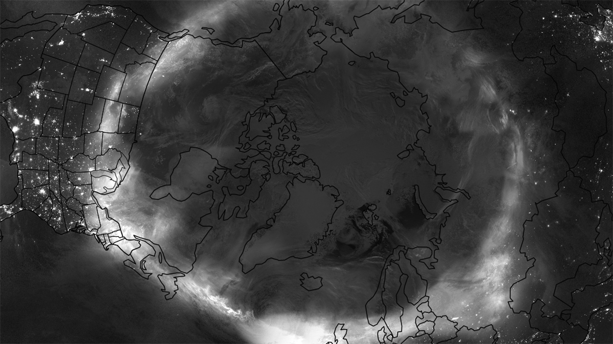 A bright ring of light surrounds the North Pole in a black-and-white composite satellite image over the Northern Hemisphere, with land areas outlined in black.