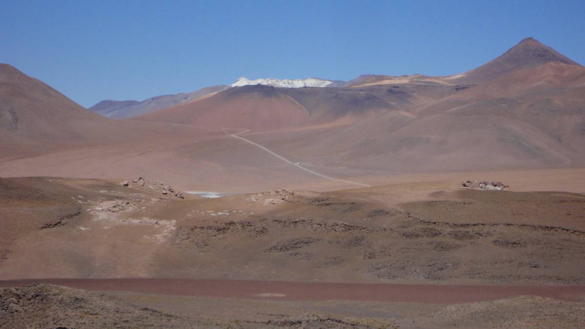 A desert mountain range at a distance.