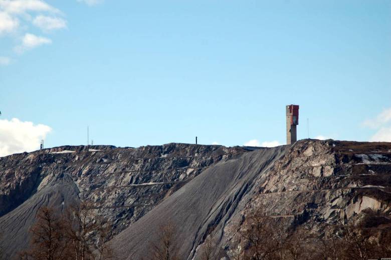 An exposed rock face of an iron mine.