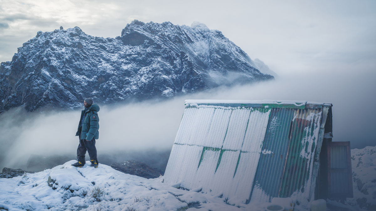 Uganda Wildlife Authority guide Muhindo Rogers overlooks the landscape surrounding Mount Baker, which once hosted a glacier that has now melted.