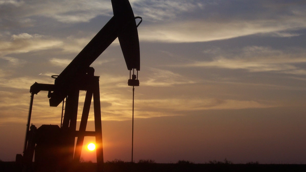 An oil pumpjack at sunrise.